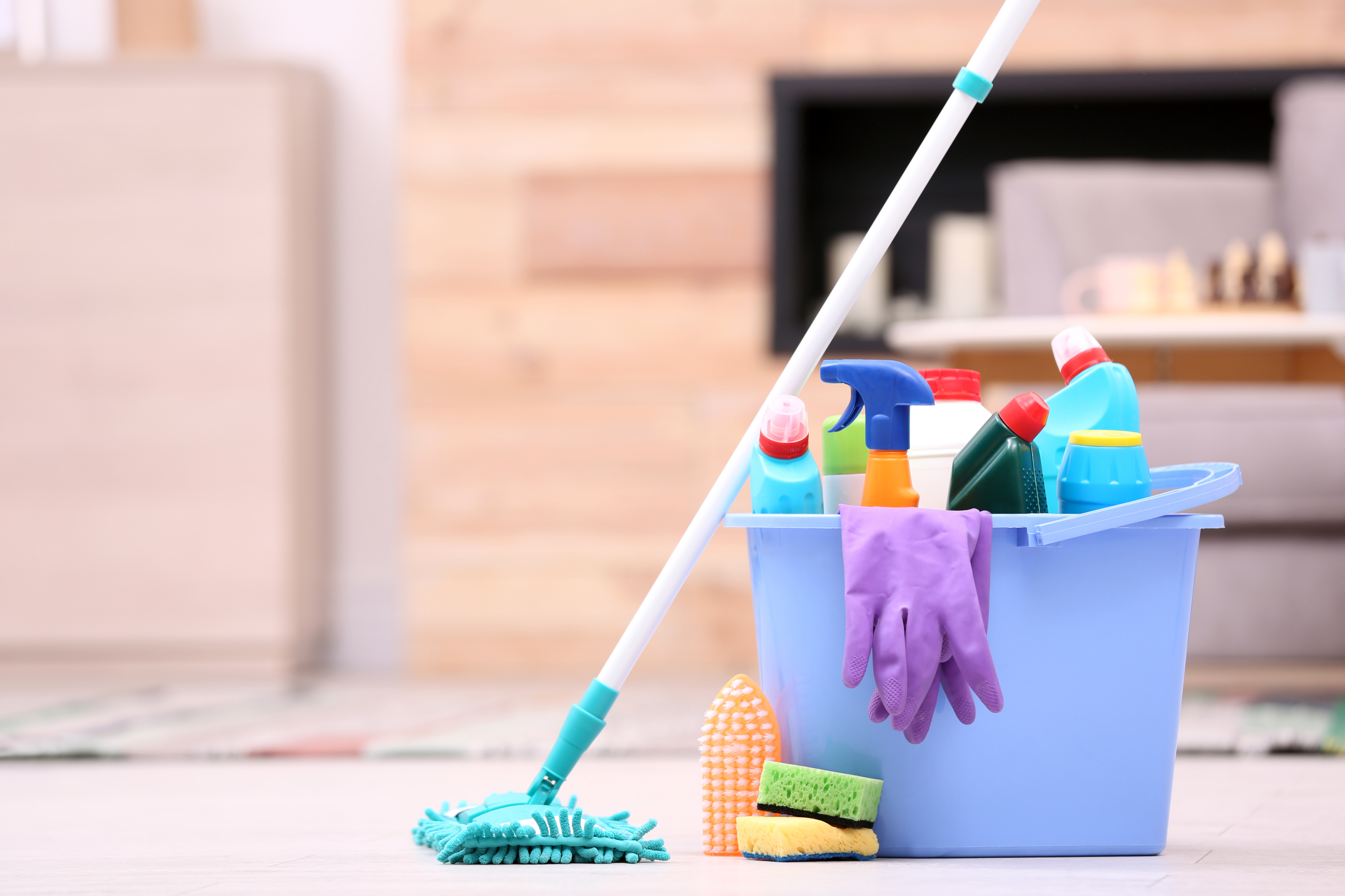 Mop, bucket, and cleaning supplies staged in a sunlit Akron-area home
